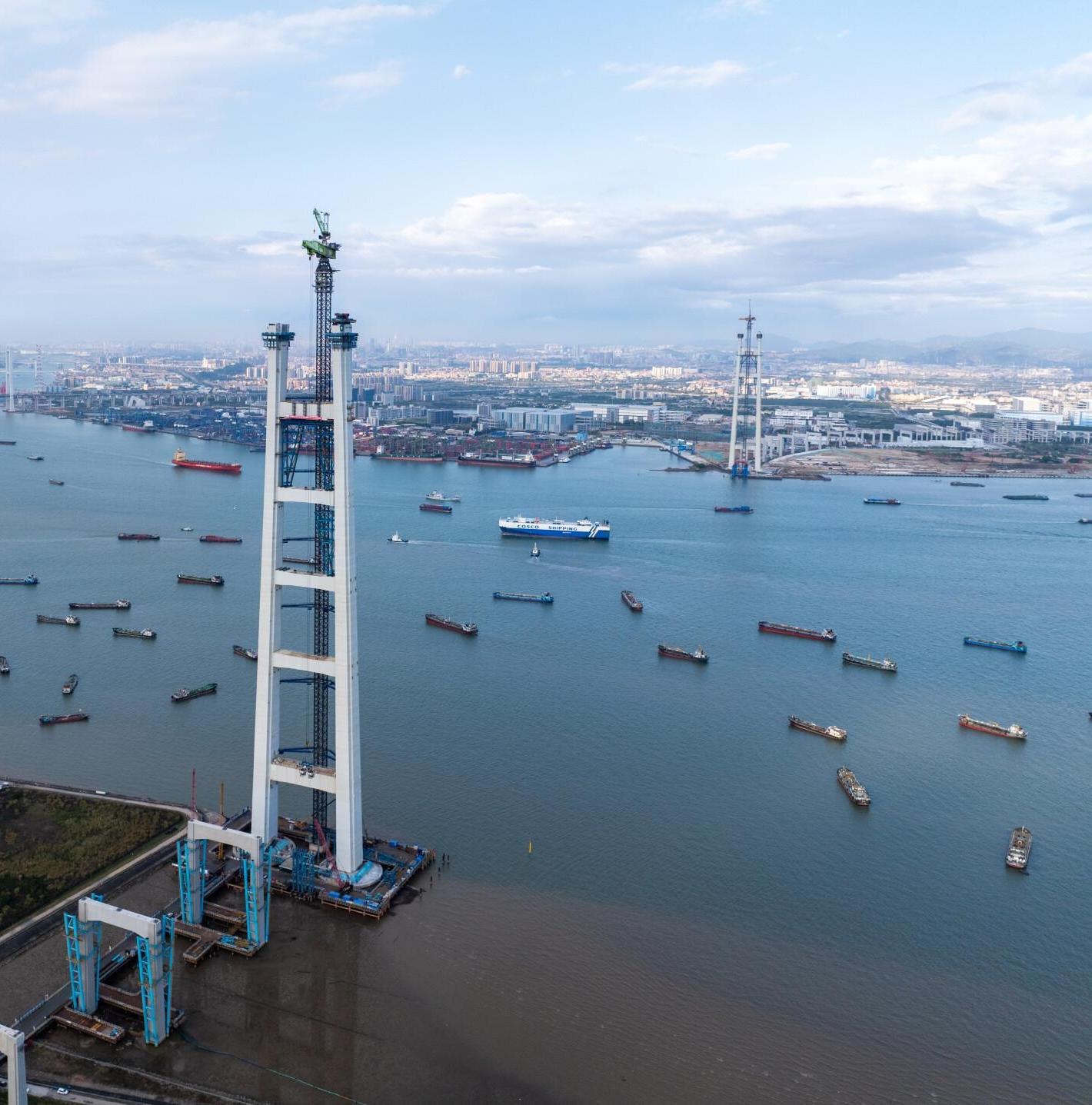 World's longest double-deck suspension bridge caps main towers